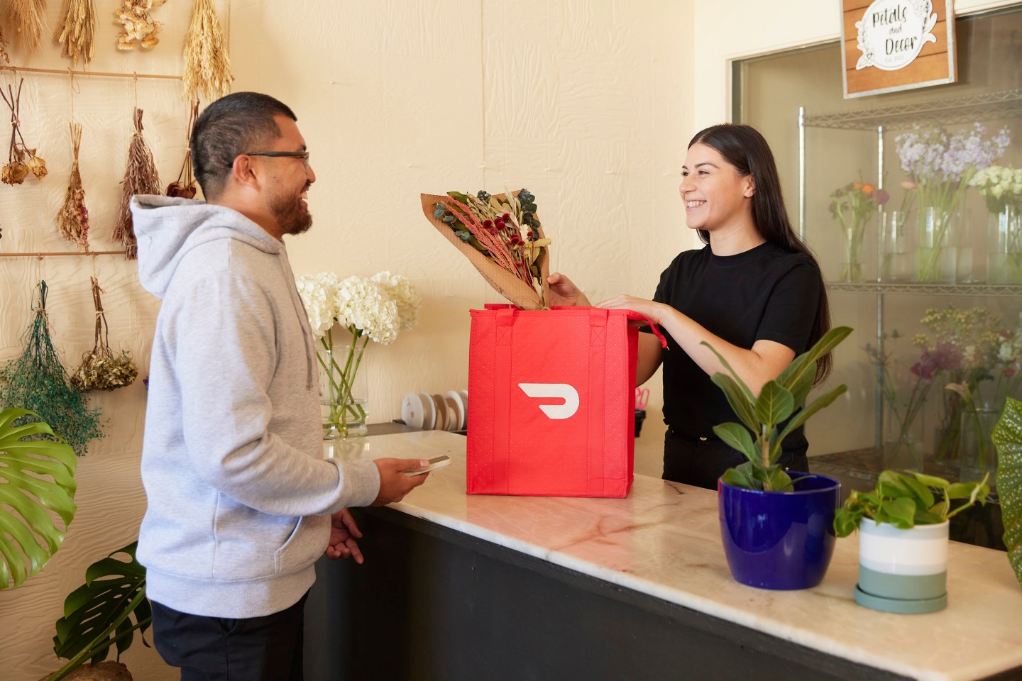 SAN FRANCISCO, CALIFORNIA - APRIL 2024: In this photo illustration, a person demonstrates making a delivery with DoorDash as a Dasher in April 2024 in San Francisco, California (Photo Illustration by Emily Dulla/Getty Images for DoorDash)